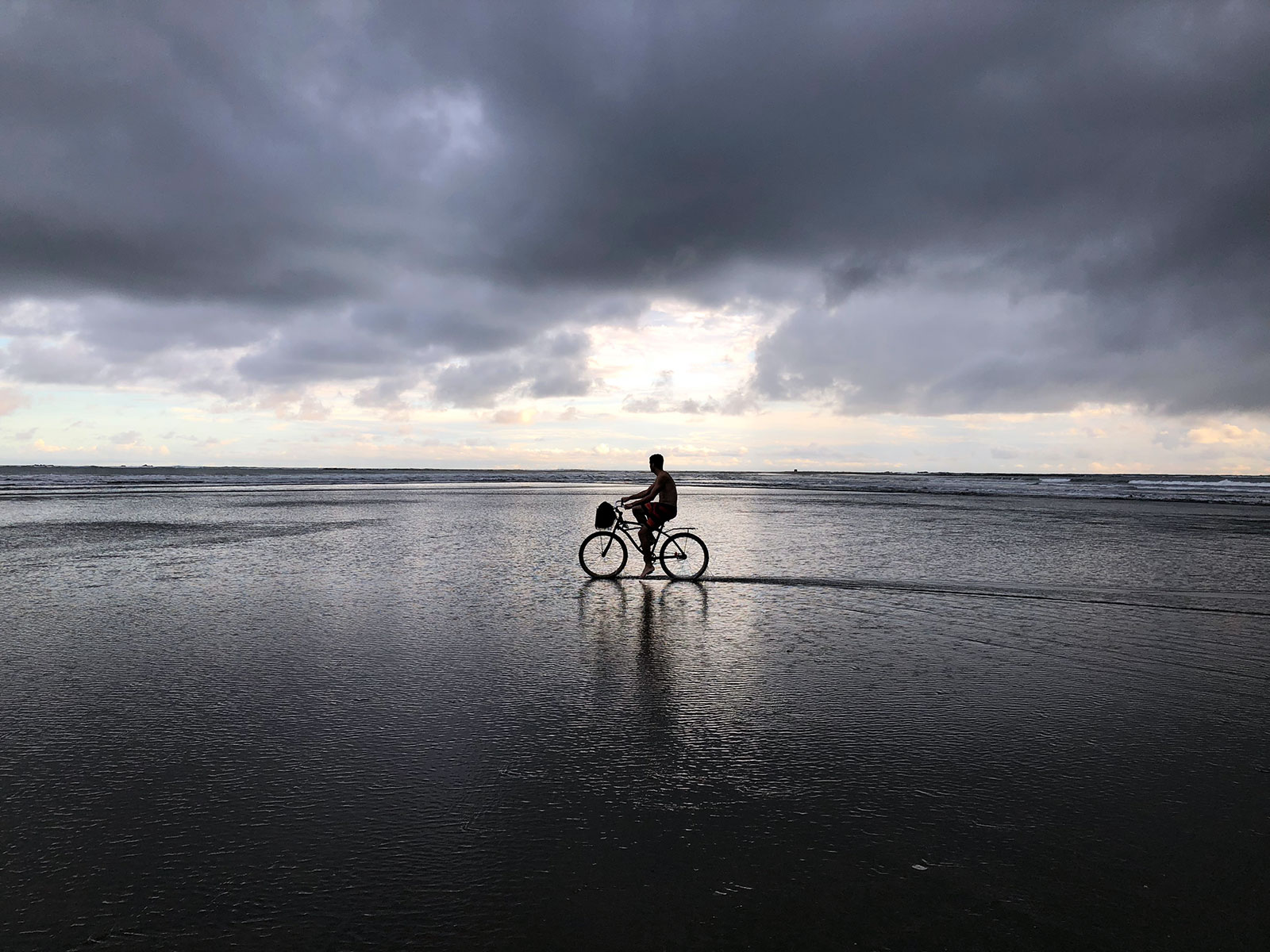 Jimmy riding a bike on the beach